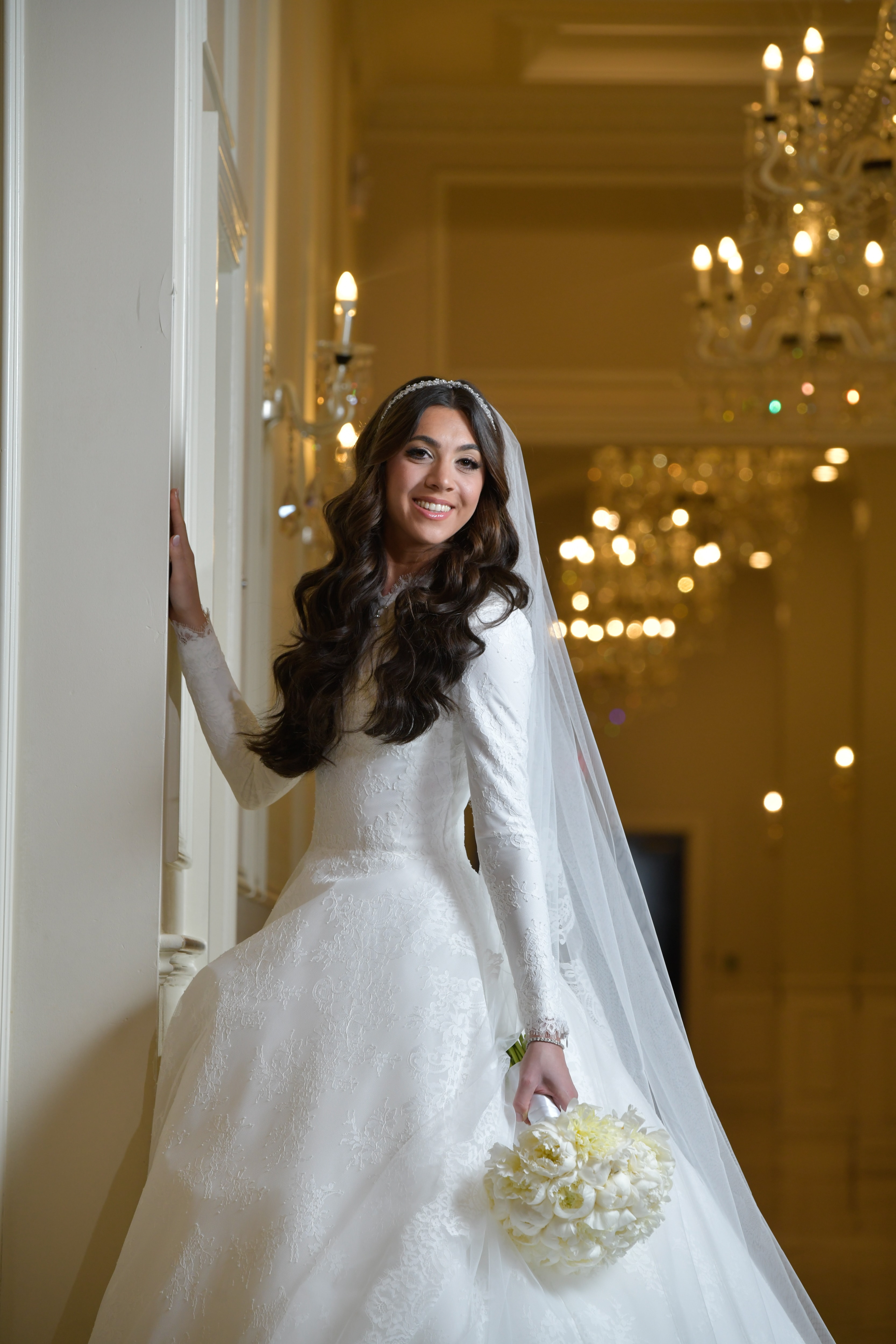 Bride at golden ballroom window light