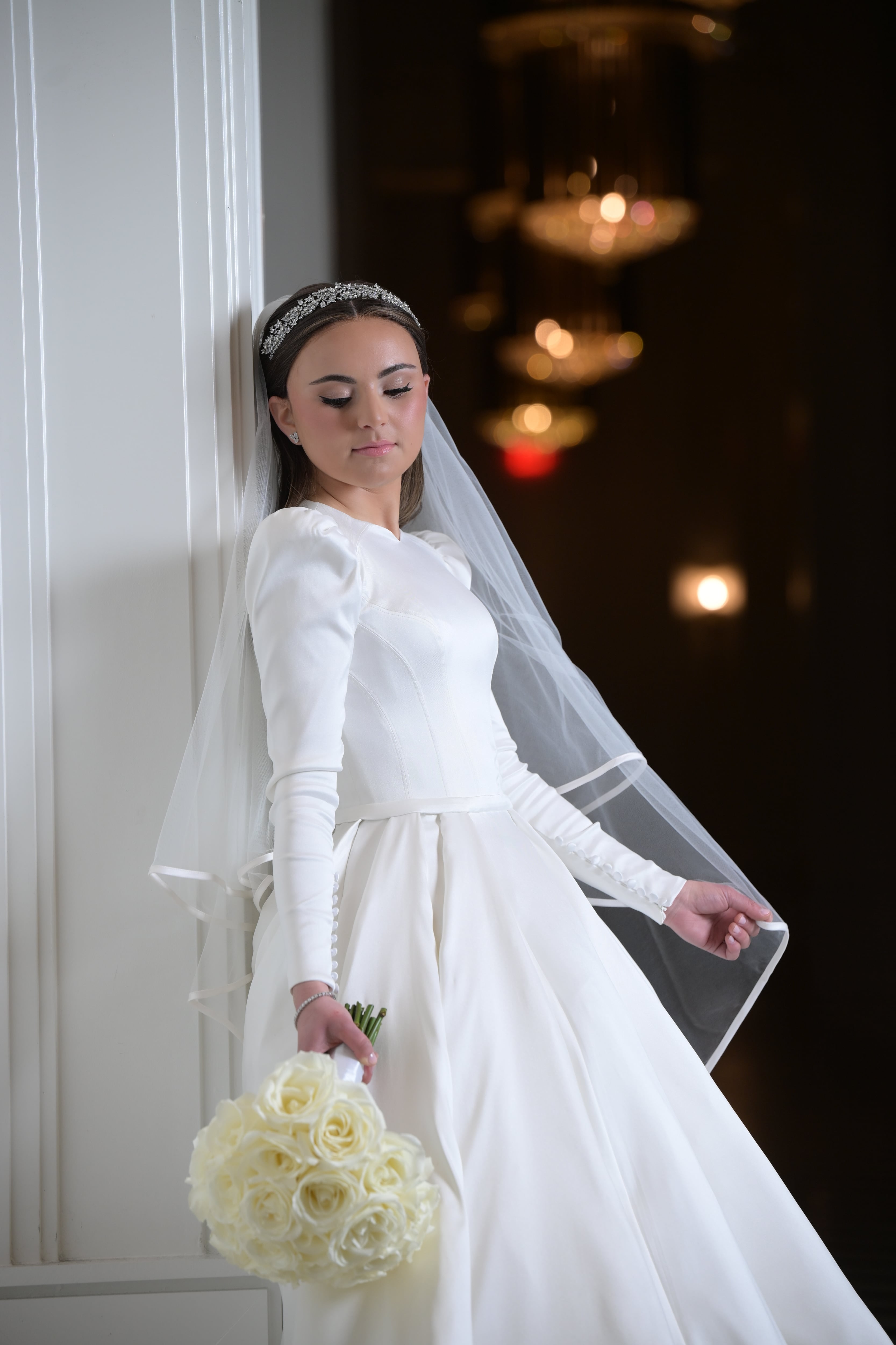 Bride in puff-sleeve satin in doorway — Friedman wedding