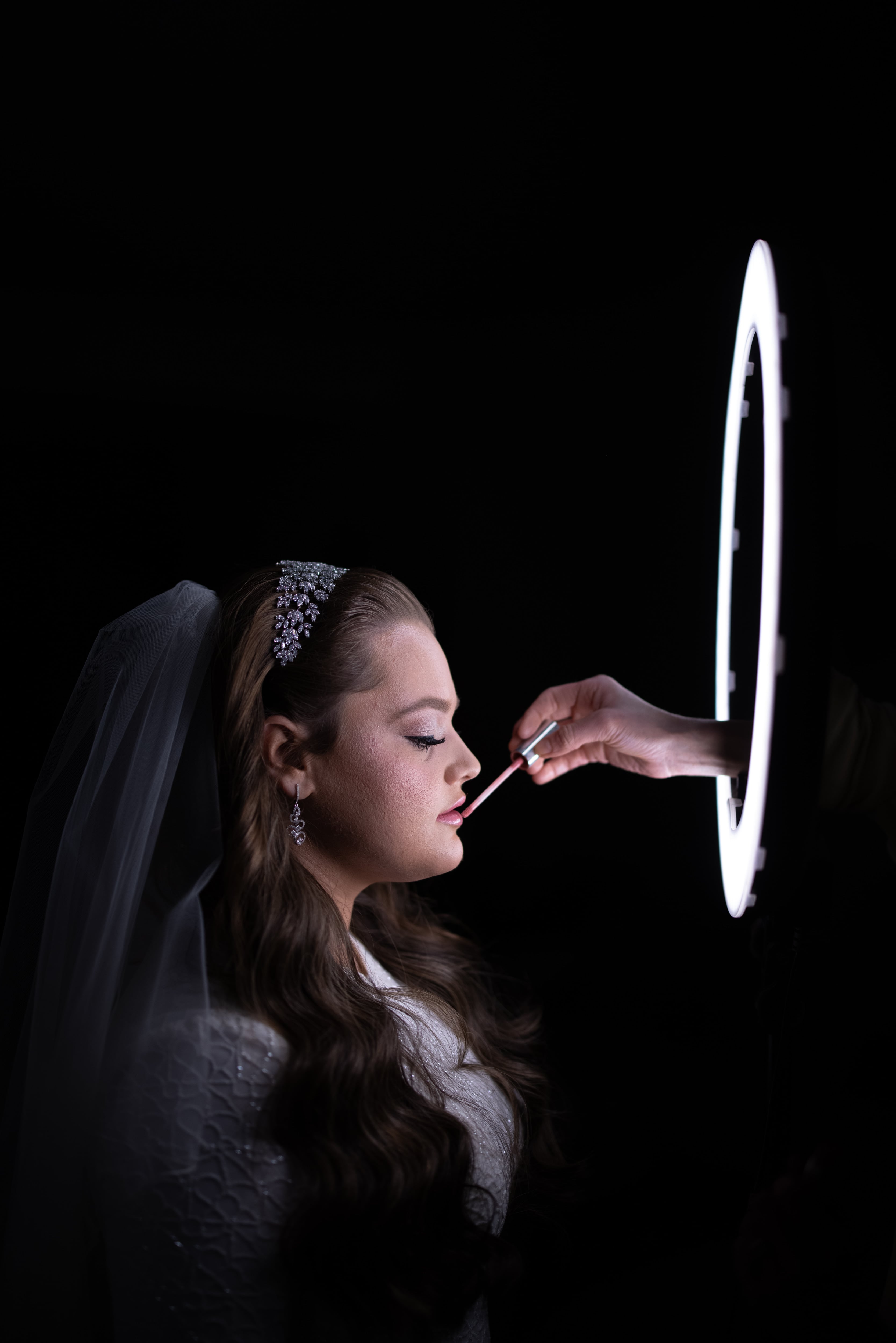 Bride in lace gown with chandelier bokeh — Goldberg wedding